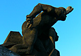 Auf diesem Bild sieht man ein Denkmal zweier Arbeiter, die mit geballten Fäusten gen Himmel streben.
